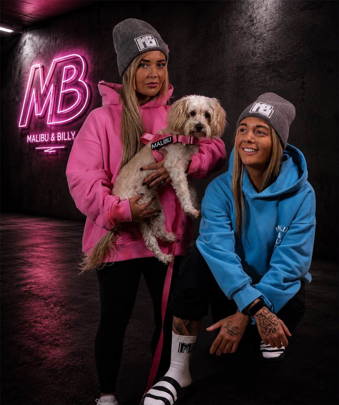 The crew in Malibu & Billy, with Malibu, under the neon MB sign